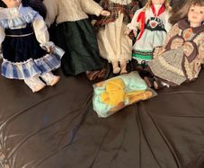5 porcelain dolls with extra clothing perfect condition