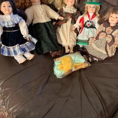 5 porcelain dolls with extra clothing perfect condition