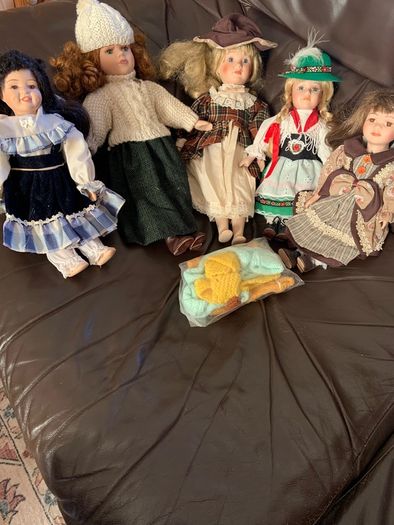 5 porcelain dolls with extra clothing perfect condition