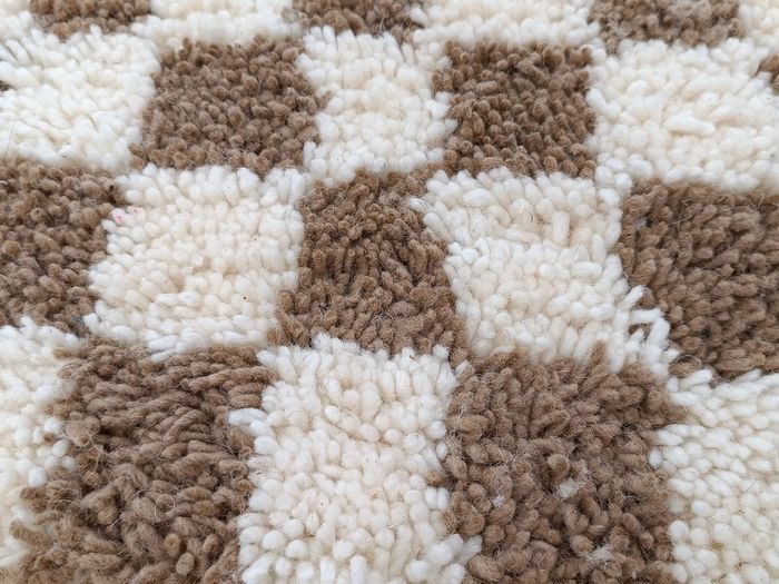 Handwoven beige checkerboard rug