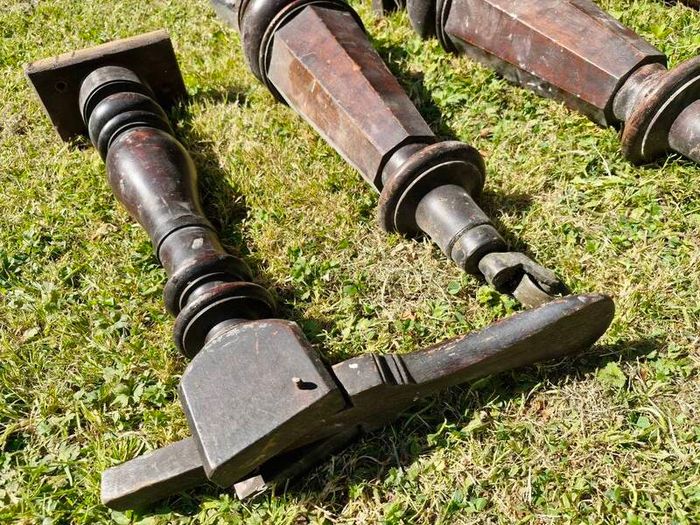 Antique mahogany piano legs with bronze casters