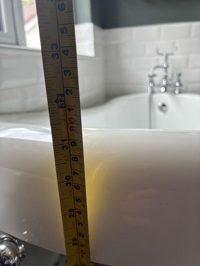 free standing bath with taps and and hose