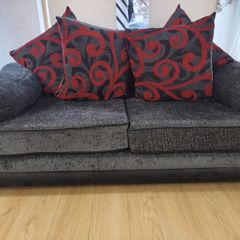 Two-seater sofa with patterned and plain back cushions