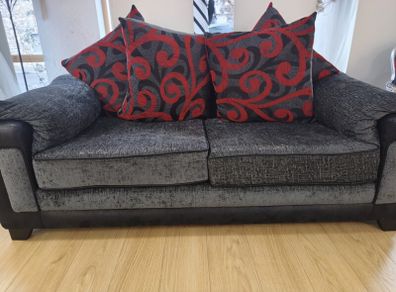 Two-seater sofa with patterned and plain back cushions
