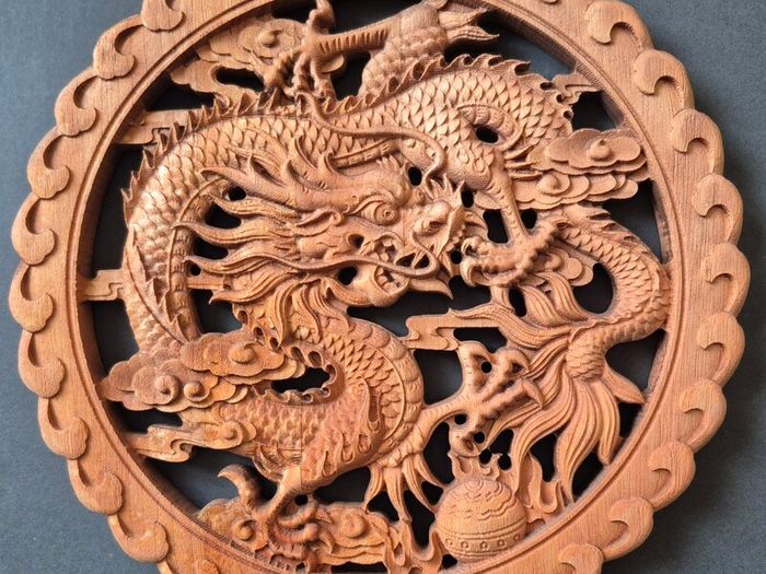 Carved decorative wooden plaque, featuring dragons.