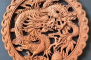 Carved decorative wooden plaque, featuring dragons.