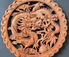 Carved decorative wooden plaque, featuring dragons.