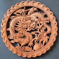 Carved decorative wooden plaque, featuring dragons.