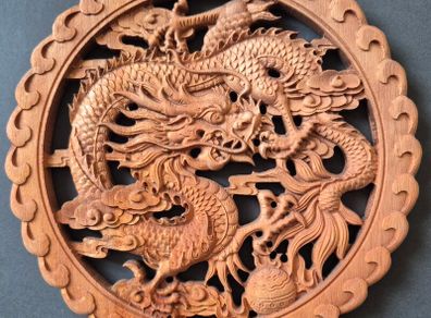 Carved decorative wooden plaque, featuring dragons.