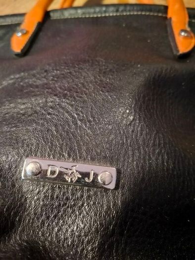 David Jones  is a classic, two-tone black pebbled Faux leather bucket bag.