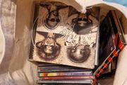 bag of U2 promo CD singles, CD albums and DVD sets