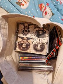 bag of U2 promo CD singles, CD albums and DVD sets