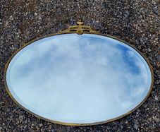 Antique oval overmantle with brass surround