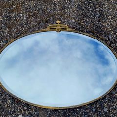Antique oval overmantle with brass surround