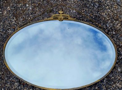 Antique oval overmantle with brass surround
