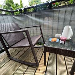 Brown rattan outdoor table and rocking chair