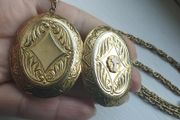 A large medallion featuring religious symbols, suspended from a long chain.
