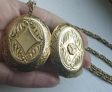 A large medallion featuring religious symbols, suspended from a long chain.