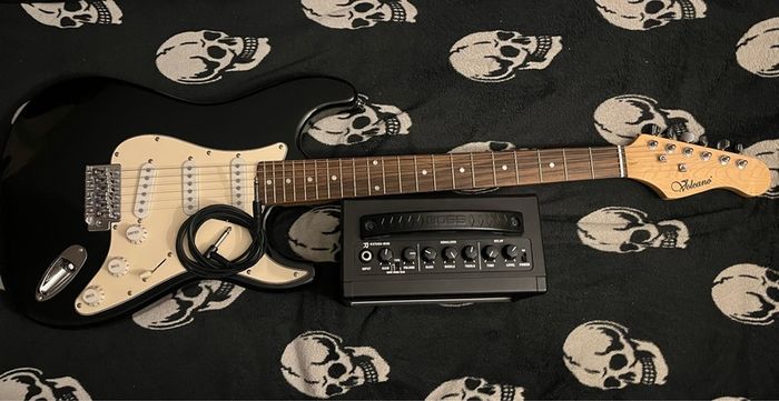 Electric guitar Stratocaster and Amp boss katana mini with cable