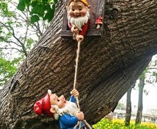 Gnome climbing statues for tree