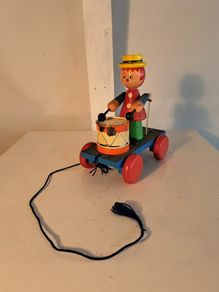 Wooden pull along drumming toy