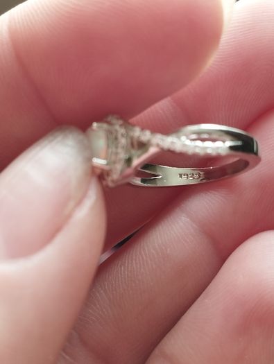 A beautiful 925 silver ring with a white lab opal surrounded by shining cubic zirconia.