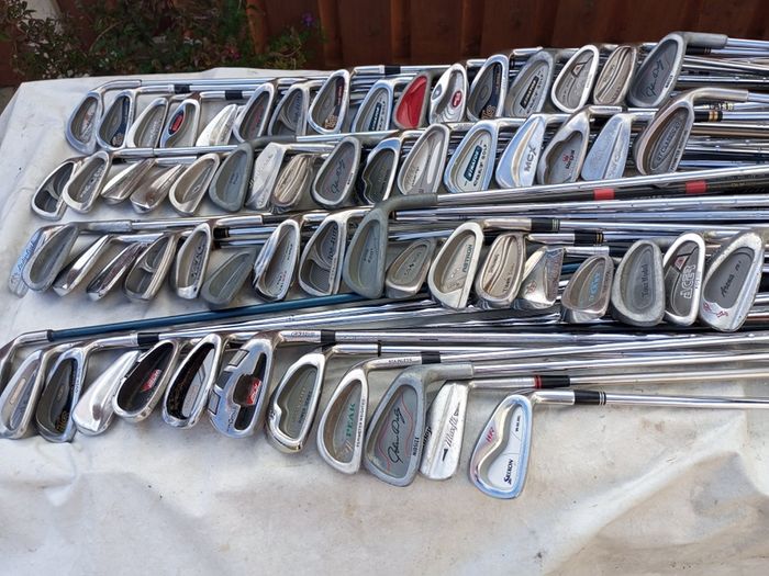 A selection of golf clubs and bags. All right handed clubs.