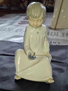 Porcelain Boy with Candle Nao by Lladro, depicting a seated child in a white nightshirt holding a small candle, postage available or collection