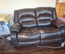 Brown 2 seater reclining couch.