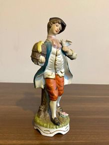 Porcelain Figurine Bisque Colonial Boy in Waistcoat Holding Bird Cage Arnart