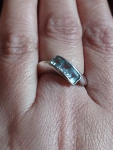 925 sterling silver trilogy ring with blue topaz.