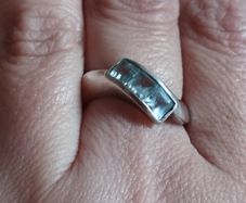 925 sterling silver trilogy ring with blue topaz.