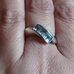 925 sterling silver trilogy ring with blue topaz.
