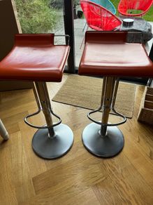 Vintage Italian orange leather bar stools.