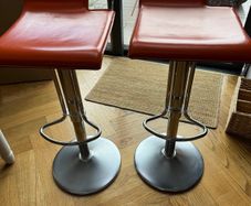 Vintage Italian orange leather bar stools.