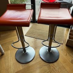 Vintage Italian orange leather bar stools.