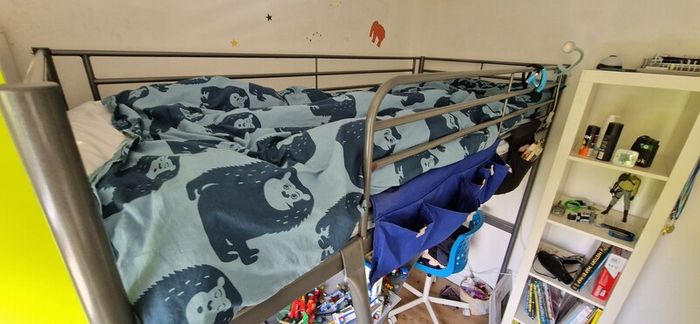 Metal framed loft bed with desk for sale.