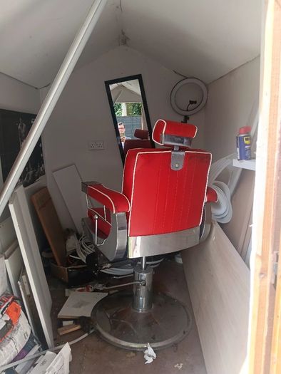 Beautiful red vintage Barbers chair with white piping