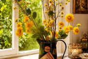 Vintage metal flower pitcher with a high-quality artificial floral arrangement