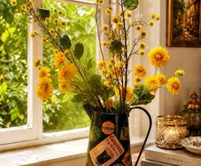 Vintage metal flower pitcher with a high-quality artificial floral arrangement