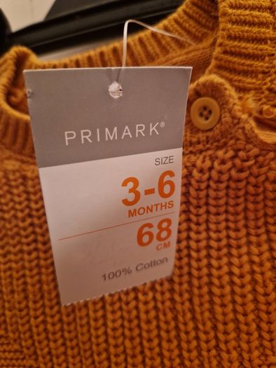 A selection of brand new baby clothes and items