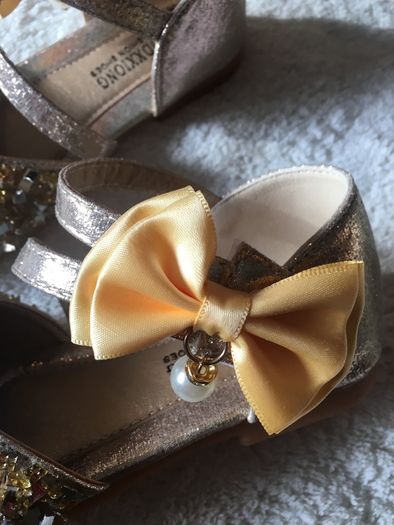 . Brand new in box , pair of girls gold shoes