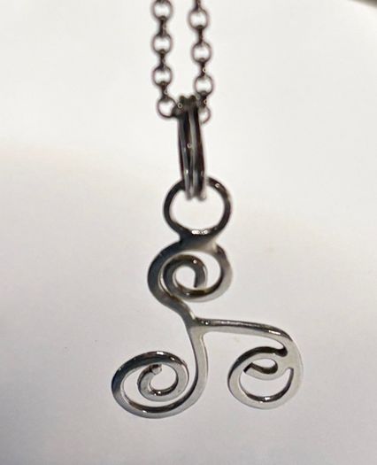 Sterling silver Triskele pendant on 18 or 20 inch chain.