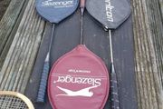 Three  badminton rackets and one squash racket