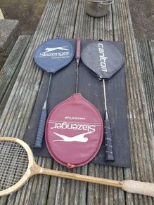 Four badminton rackets and one squash racket