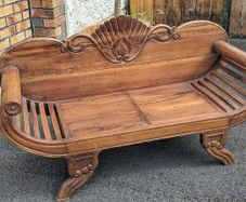 Solid wood 2-seater with scrolled arms and carving