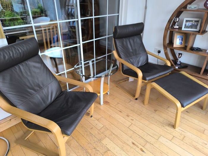 Ikea Poang brown leather chairs and matching footstool with occasional table