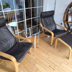 Ikea Poang brown leather chairs and matching footstool with occasional table