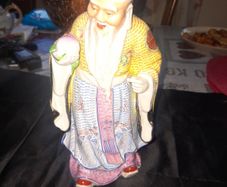 Beautiful Large Chinese Shou Xing porcelain figurine depicting the God of Longevity. It features an elderly man with a prominent bald head, holding a peach, which symbolizes long life, Postage Available, no chips or cracks