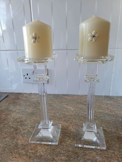 2 glass candle holders and candles